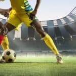 two football players fighting for a ball