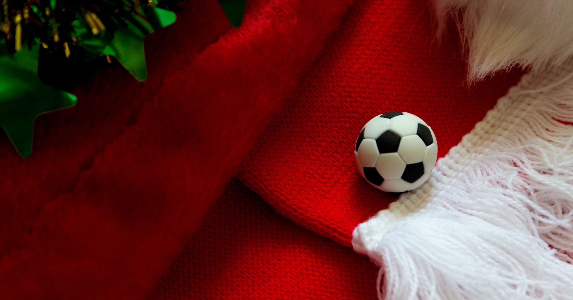 a football laying on boxing day decorations