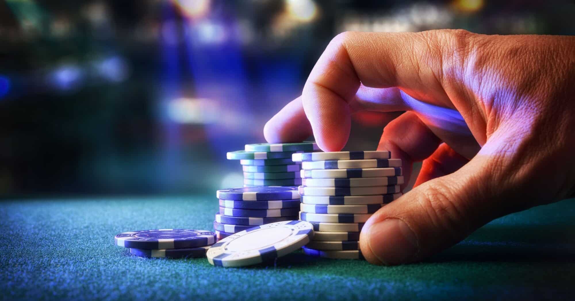 a person moving chips on a casino table