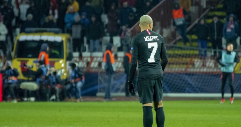mbappe standing in a football field