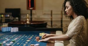 a woman betting on a roulette table