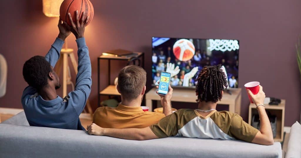 people watching a game and betting