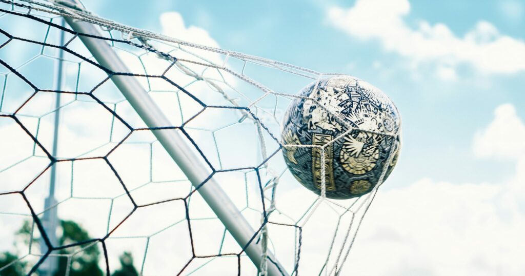 Football ball crossing the net