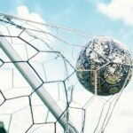 Football ball crossing the net