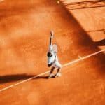 Person serving a tennis ball