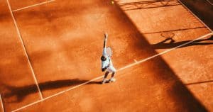 Person serving a tennis ball