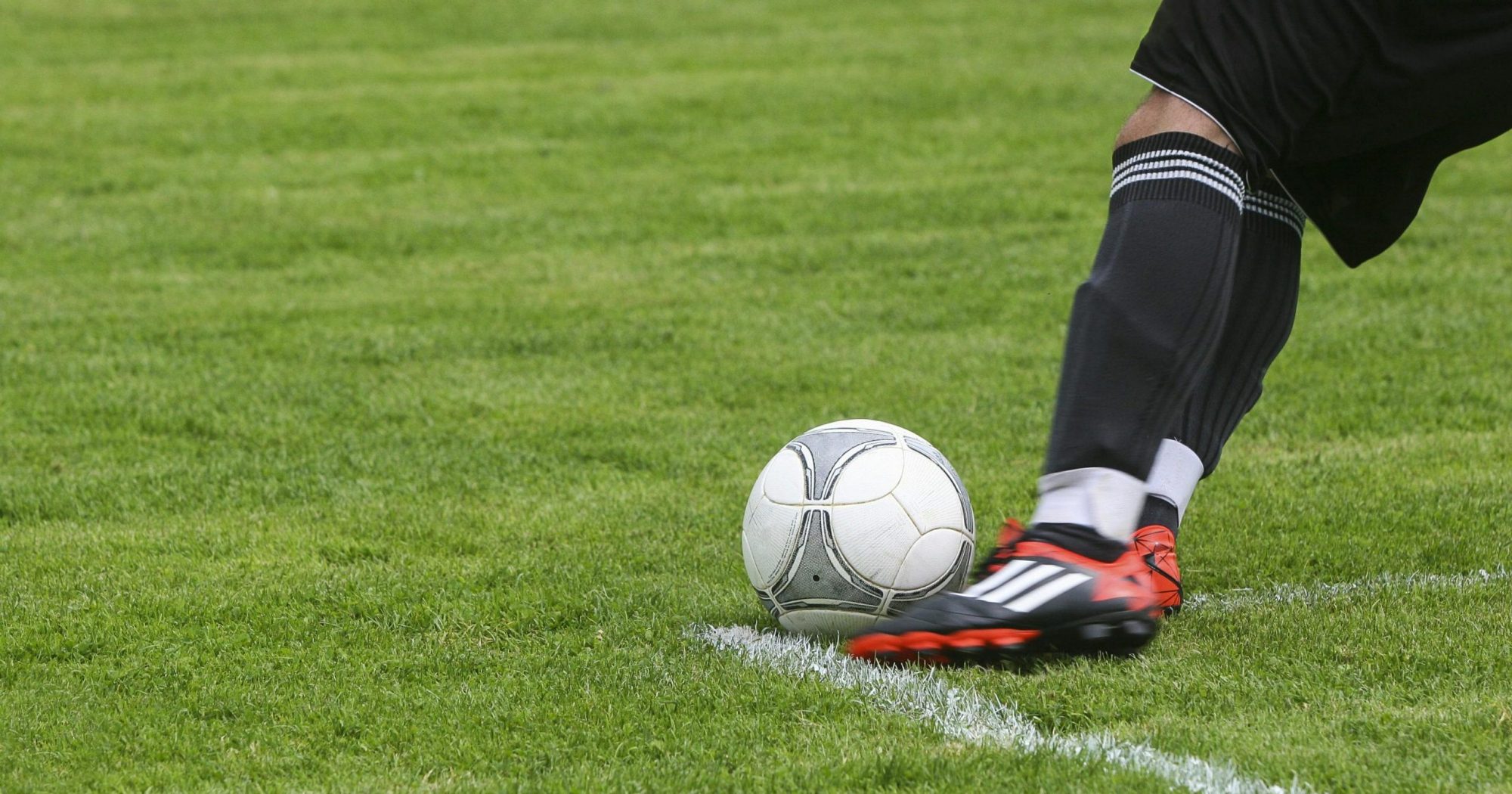 Man kicking a football ball