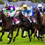 Multiple race horses on a track