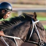 Man on a horse in a horse track