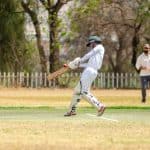 Person playing cricket on the field