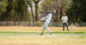 Person playing cricket on the field