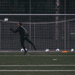 Man shooting into a football goal