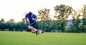 Football player doing trick on the field