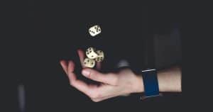 Man juggling playing dices in his hands