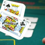 Man throwing two cards in the air