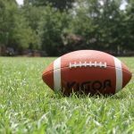 Rugby ball on the grass field