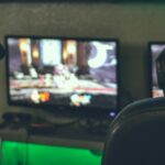 Two people playing games on a computer