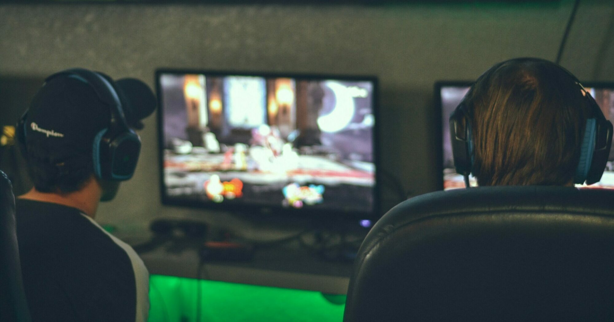 Two people playing games on a computer