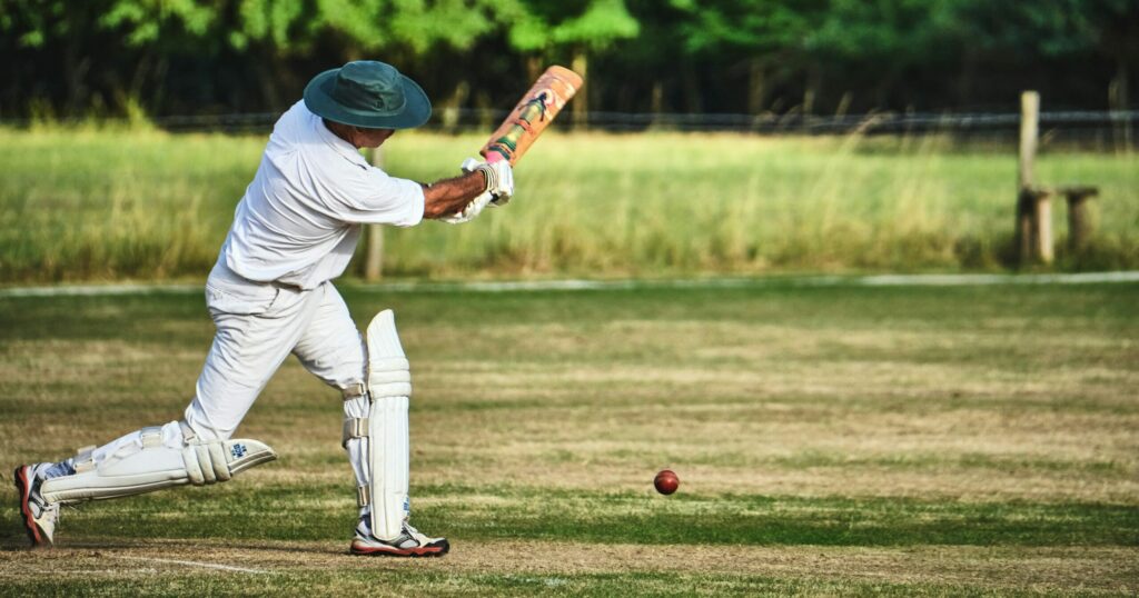 Man hitting a Cricket ball