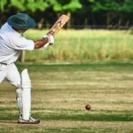 Man hitting a Cricket ball