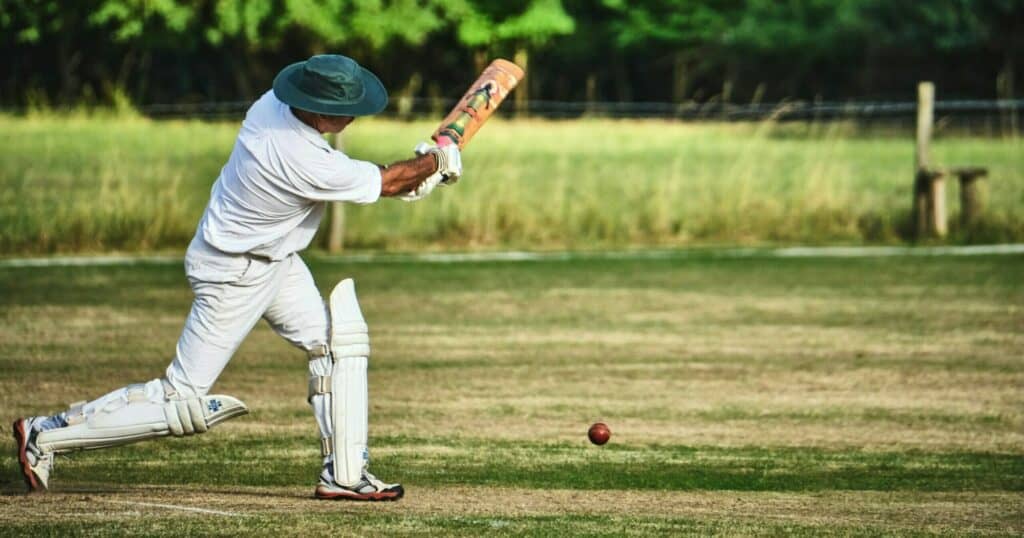 Man hitting a Cricket ball