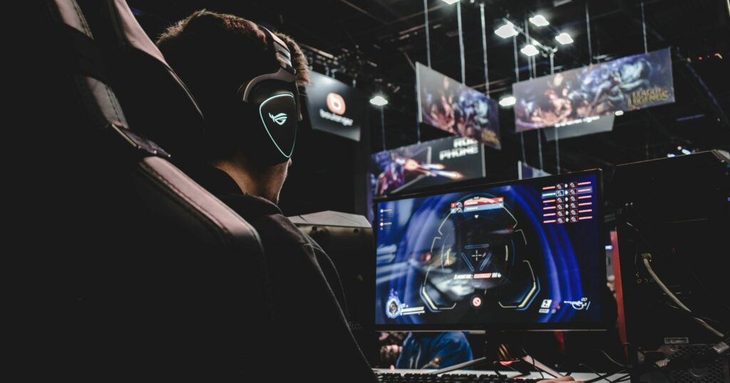 Person sitting on a computer, and playing a game