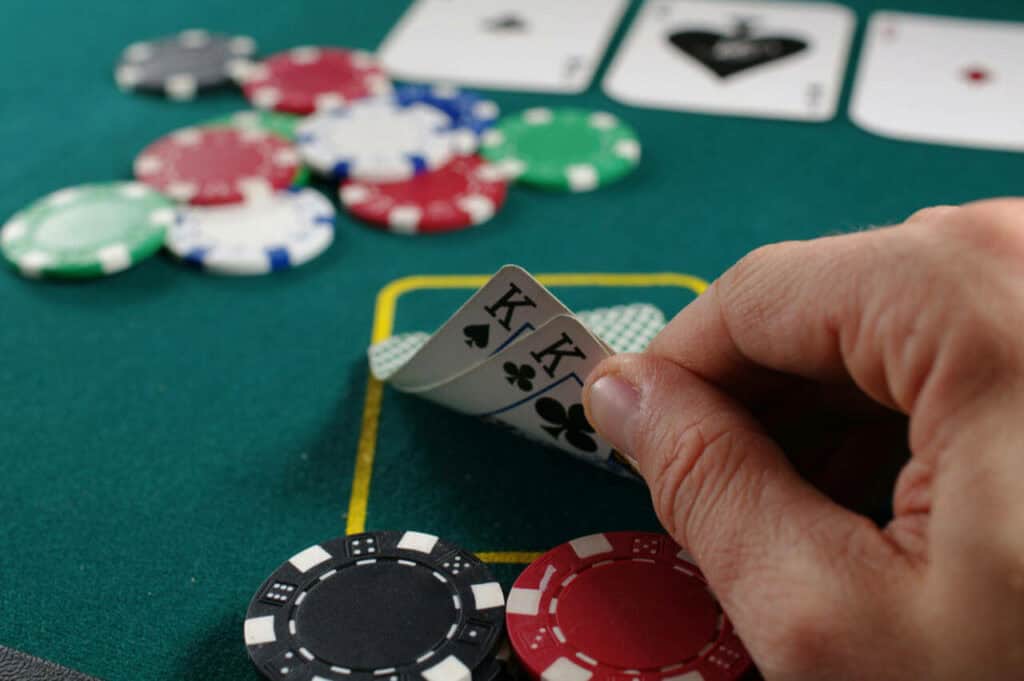 Man looking at it's poker game hand