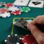 Man looking at it's poker game hand