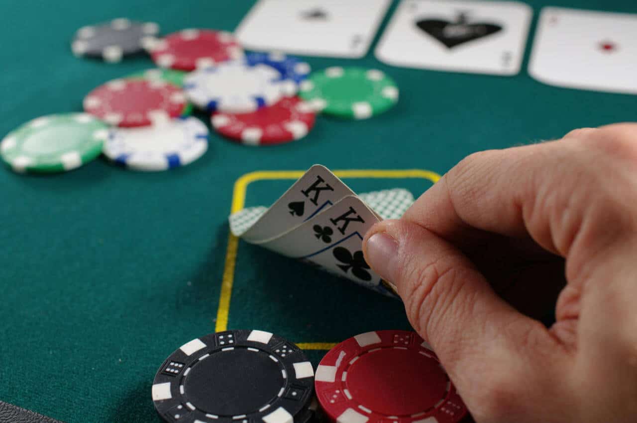Man looking at it's poker game hand
