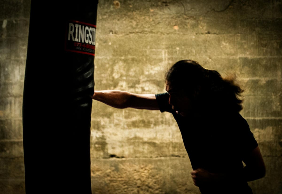 Man punching a boxing bag