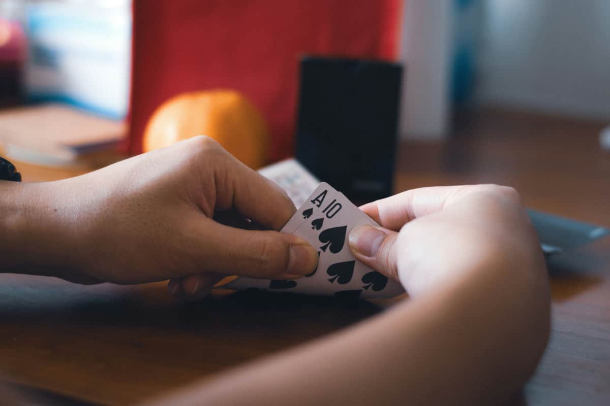 Man looking at his playing cards