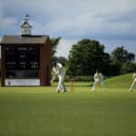 People playing Cricket in the field