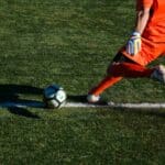 Man kicking a football ball