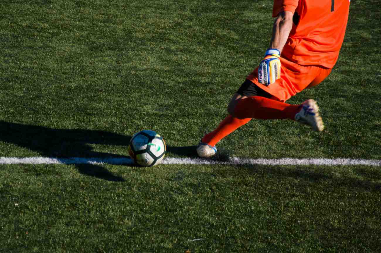 Man kicking a football ball