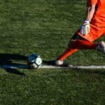 Man kicking a football ball