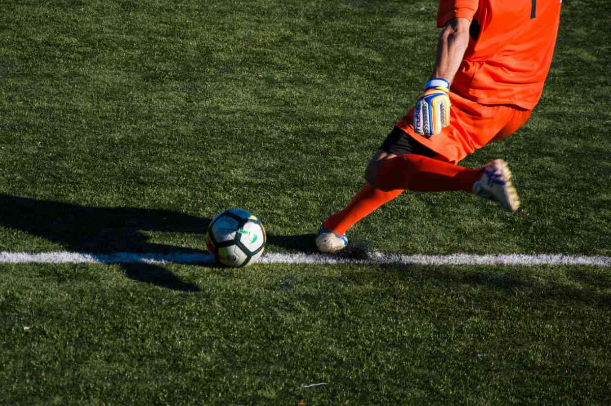 Man kicking a football ball