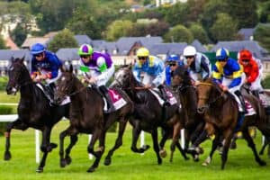 Multiple horses on a racing track