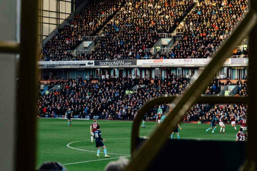 Football stadium filled with people watching a game