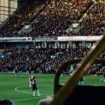 Football stadium filled with people watching a game