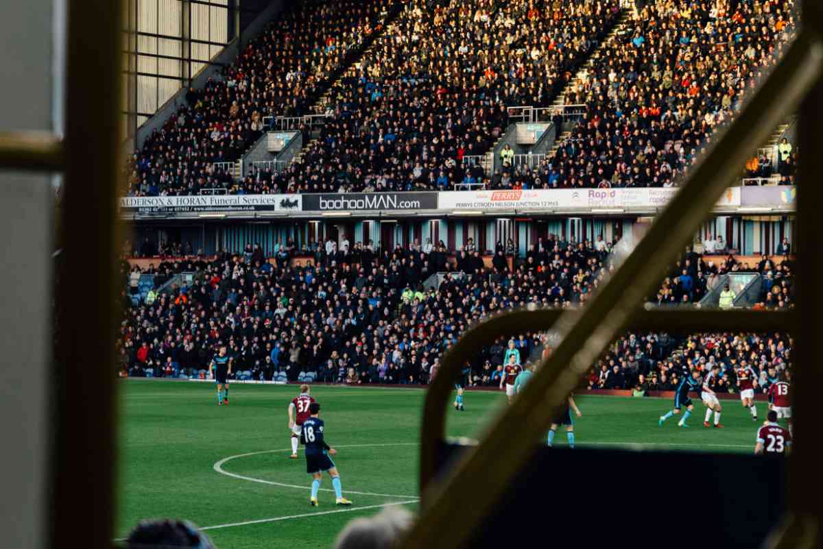 Football stadium filled with people watching a game