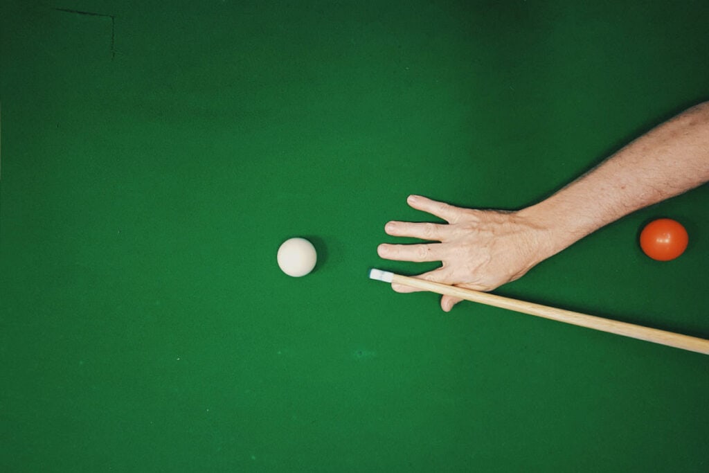 Man playing a game of snooker