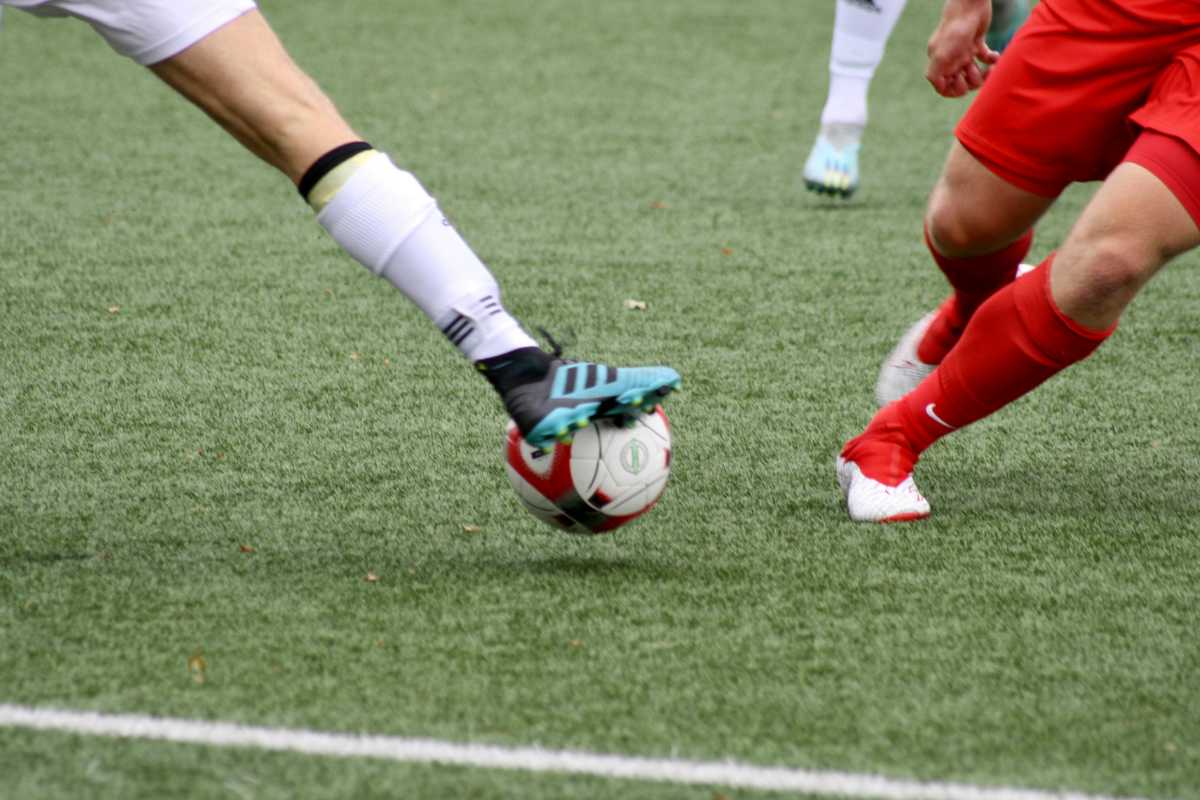 Two men playing football on the field