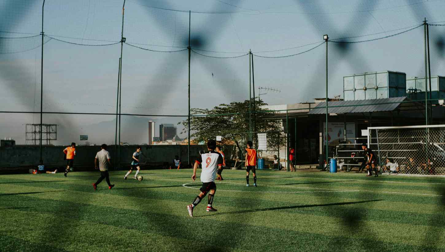 Multiple people playing football on the field