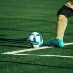 Man kicking a football ball