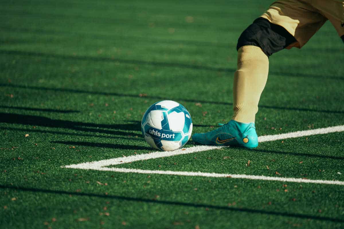 Man kicking a football ball
